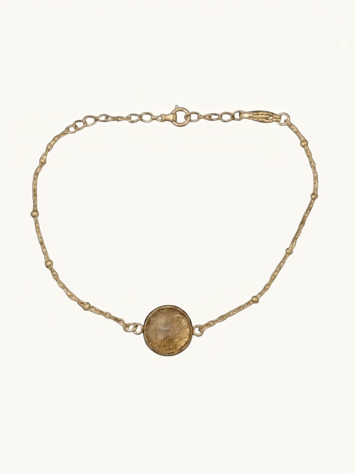 Citrinmagi armband med rund fattning fylld av 24K guldflakes, tillverkat i 18k guldpläterat rostfritt stål.