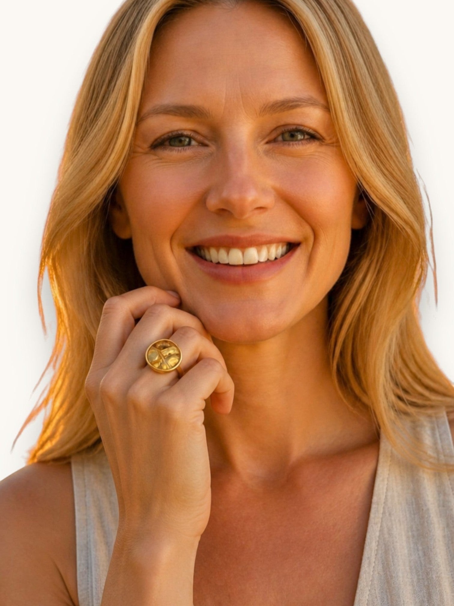 Kvinna bär en rund guldpläterad Citrinmagi ring med en naturlig citrinkristall, handgjord design i 18k guld.